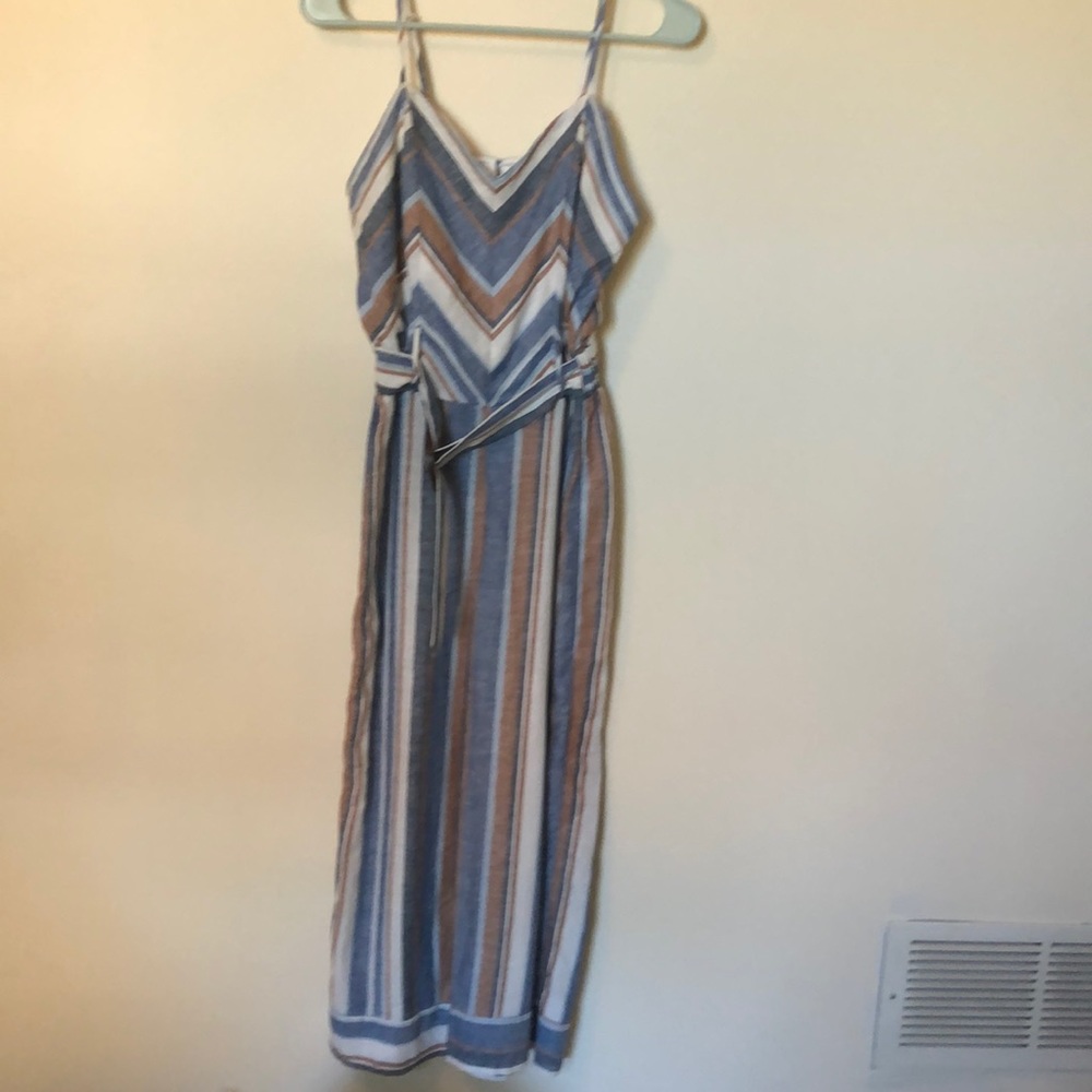 Jumpsuit with adjustable straps, built in belt an elastic waistband.